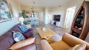 A modern living room with a sofa, coffee table, and TV.
