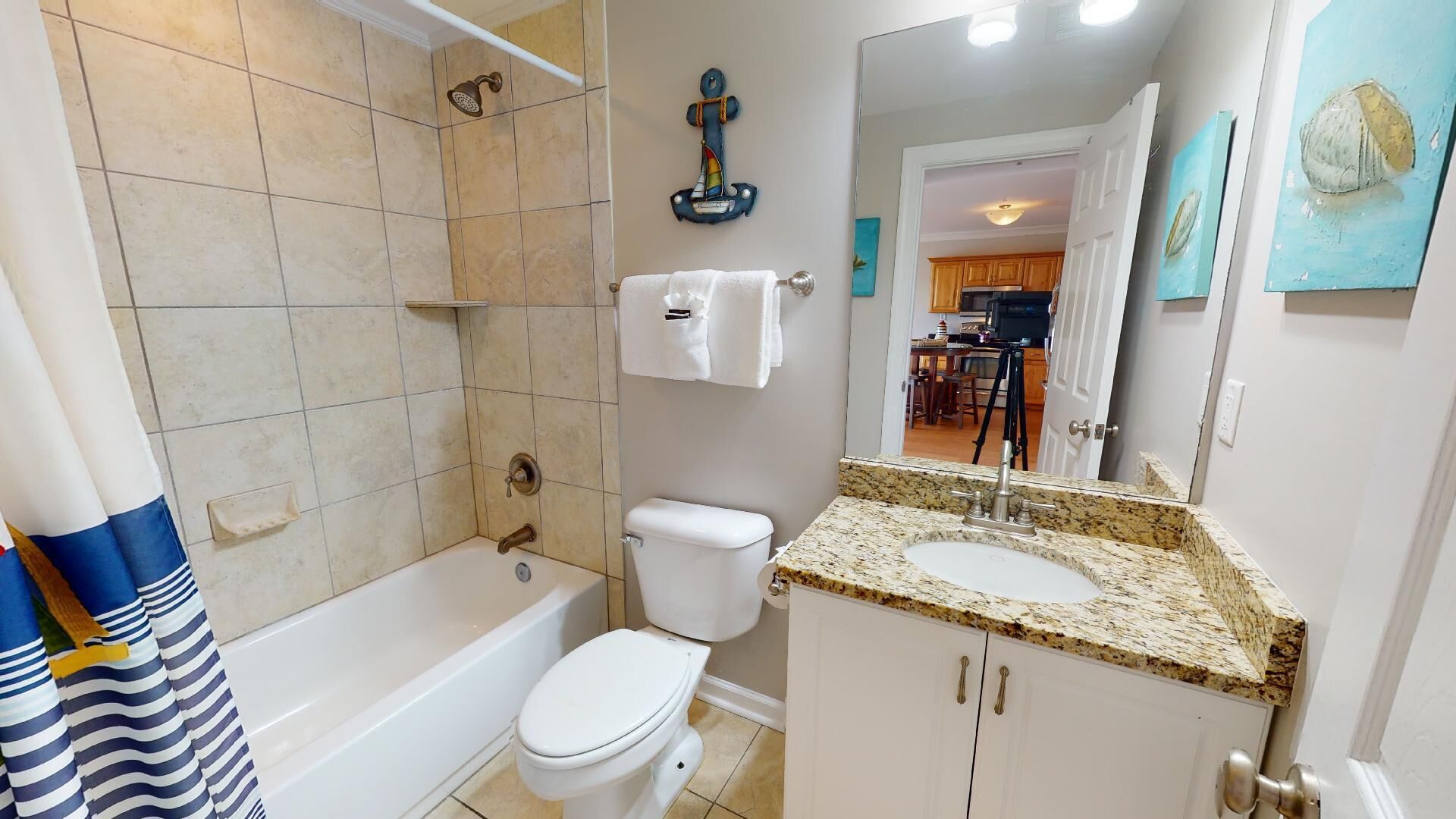 A bathroom with a bathtub, toilet, and sink.