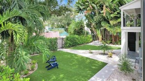 A well-maintained garden with a lawn, seating area, and a pool. - My Miami Getaway, Apt 1 (Miami)