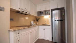 Full-size fridge, microwave, stovetop, cookware/dishes/utensils