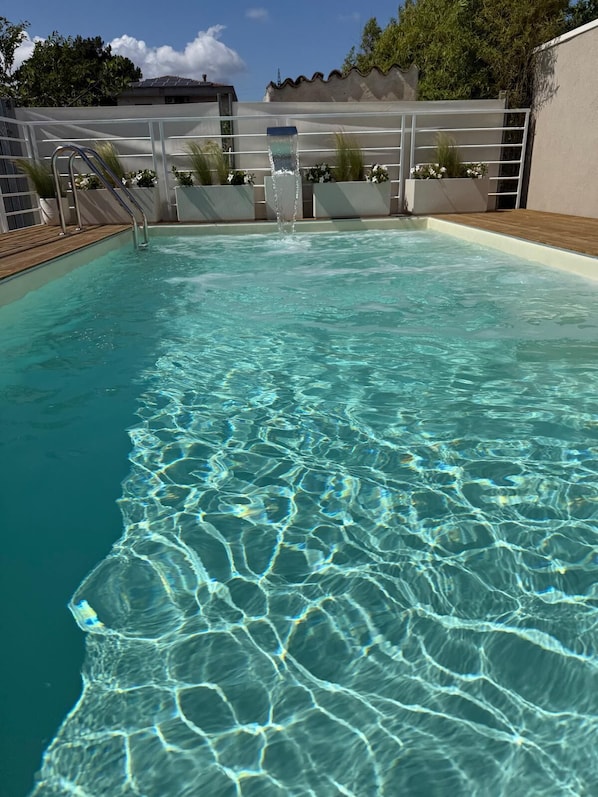 Seasonal outdoor pool, pool loungers