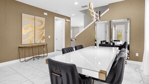 A modern conference room with a large glass table, black chairs, and a minimalist design. - Last Minute Disney! Private Pool, Hot Tub & Themed Bedrooms. Book Now! #91365 (Orlando)