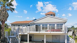 A two-story house with a covered porch, a staircase, and a small deck area. - “AH!” It's time to relax at the beach! (Avon)