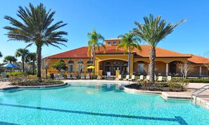 A resort with a large pool, palm trees, and a yellow building with arched windows. - Last Minute Disney Getaway! Private Pool, Hot Tub & Game Room. Book Now! #128323 (Orlando)