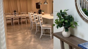 A modern kitchen with a dining area, featuring a large island, pendant lights, and a potted plant. - Last Minute Disney! Private Pool, Hot Tub & Themed Bedrooms. Book Now! #119785 (Orlando)