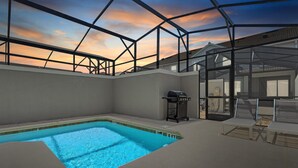 En inomhuspool med utsikt över solnedgången genom ett glastak.