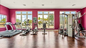 A gym with treadmills, elliptical machines, and weight equipment.