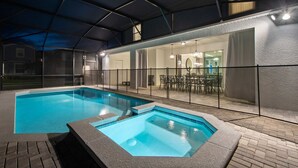 An indoor swimming pool with a glass enclosure, a hot tub, and a patio area with outdoor furniture. - Last Minute Disney Getaway! Private Pool & Themed Bedrooms. Book Now! #136701 (Orlando)