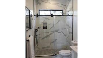 Shower, hair dryer, towels, shampoo