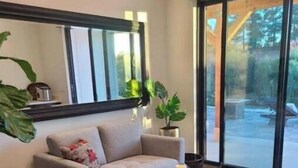 A modern living room with a sofa, armchair, and a coffee table. - Villa Blanc, Private Individual Suite @ Hidden Hacienda (Temecula)