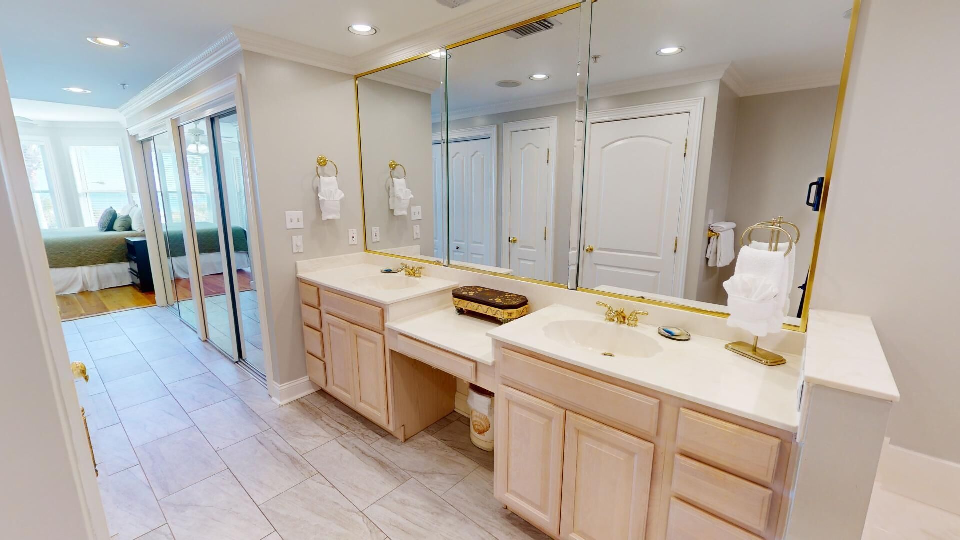 A modern bathroom with dual sinks, a large mirror, and a walk-in shower.