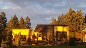 A modern house with a large garage and a covered outdoor area.