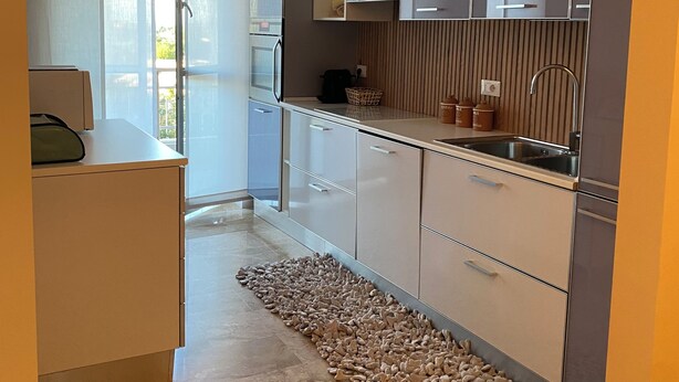 A modern kitchen with a built-in oven, a sink, and a countertop. - Apartment near american school from the center of milan from IEO and Humanitas (Noverasco)