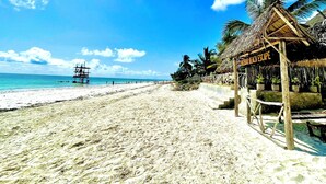 A beach with a thatched-roof structure labeled "BAR BEACH ESCAPE". - Zanzibar beach escape  (Bwejuu)