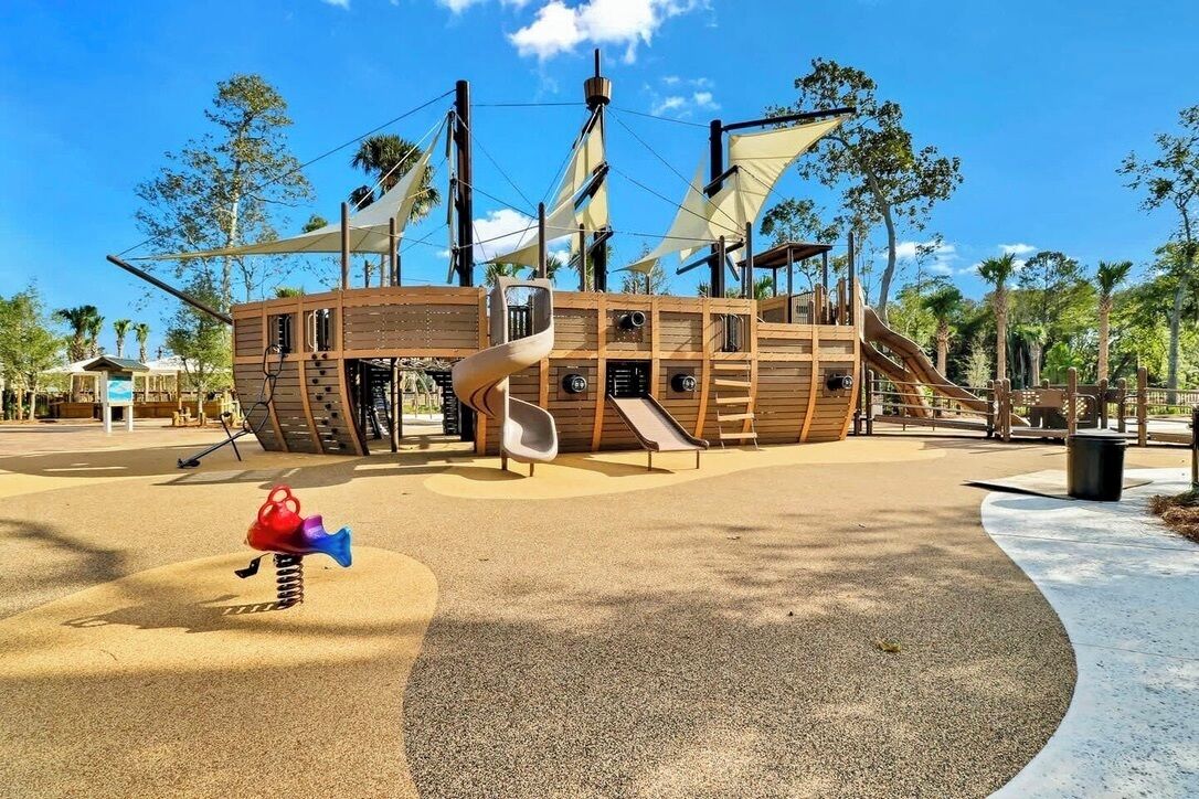 A playground with a pirate ship theme, including slides and a spiral slide.