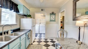 A kitchen with a checkered floor, a sink, cabinets, and a refrigerator. - Home < 3 Mi to Rte 66 & Lake Lou Yaeger! (Litchfield)