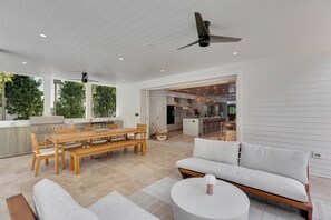 A modern open-plan living space with a dining area, kitchen, and seating area.
