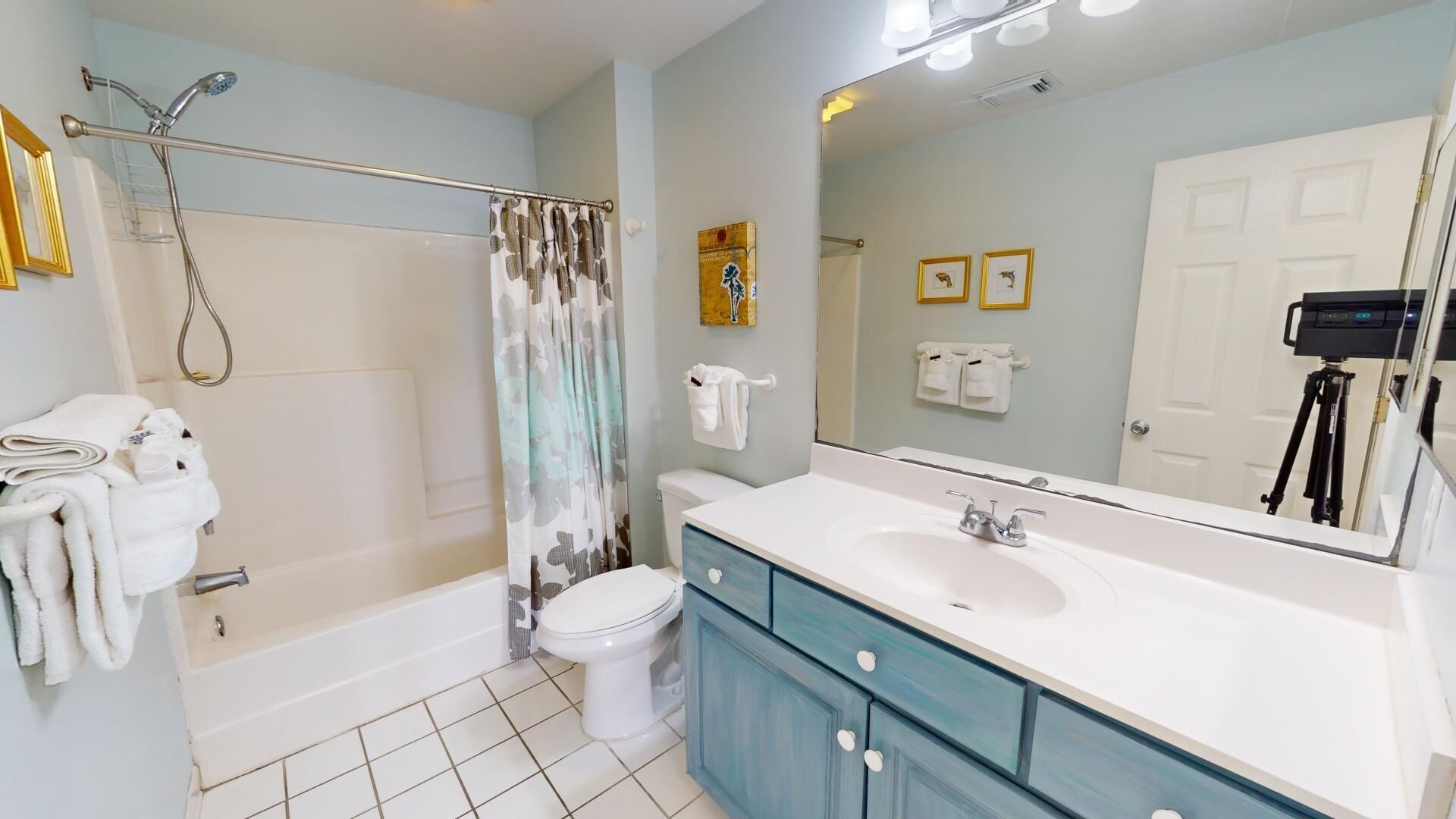 A bathroom with a bathtub, toilet, and sink.