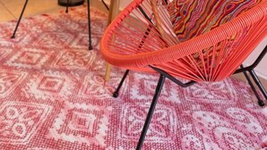 A room with two orange woven chairs, a round table with a plant, and a large wall hanging. - Casa Paloma「UNIT 2 「Judith」Walk to beach (San Juan)