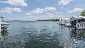 A waterfront property with docked boats and a clear view of the water.