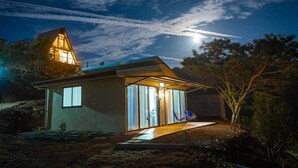 A modern house with a large glass window and a small porch area. - Ocean View House - Monteverde (Sierra)