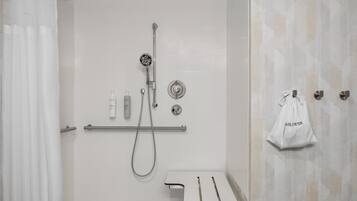 A modern bathroom with a shower, toilet, and towel rack.