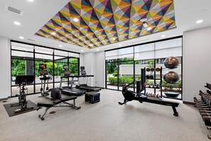 A gym with treadmills, weight machines, and exercise balls. - Home2 Suites By Hilton Raleigh Crabtree (Raleigh)