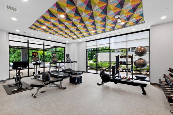A gym with treadmills, weight machines, and exercise balls. - Home2 Suites By Hilton Raleigh Crabtree (Raleigh)