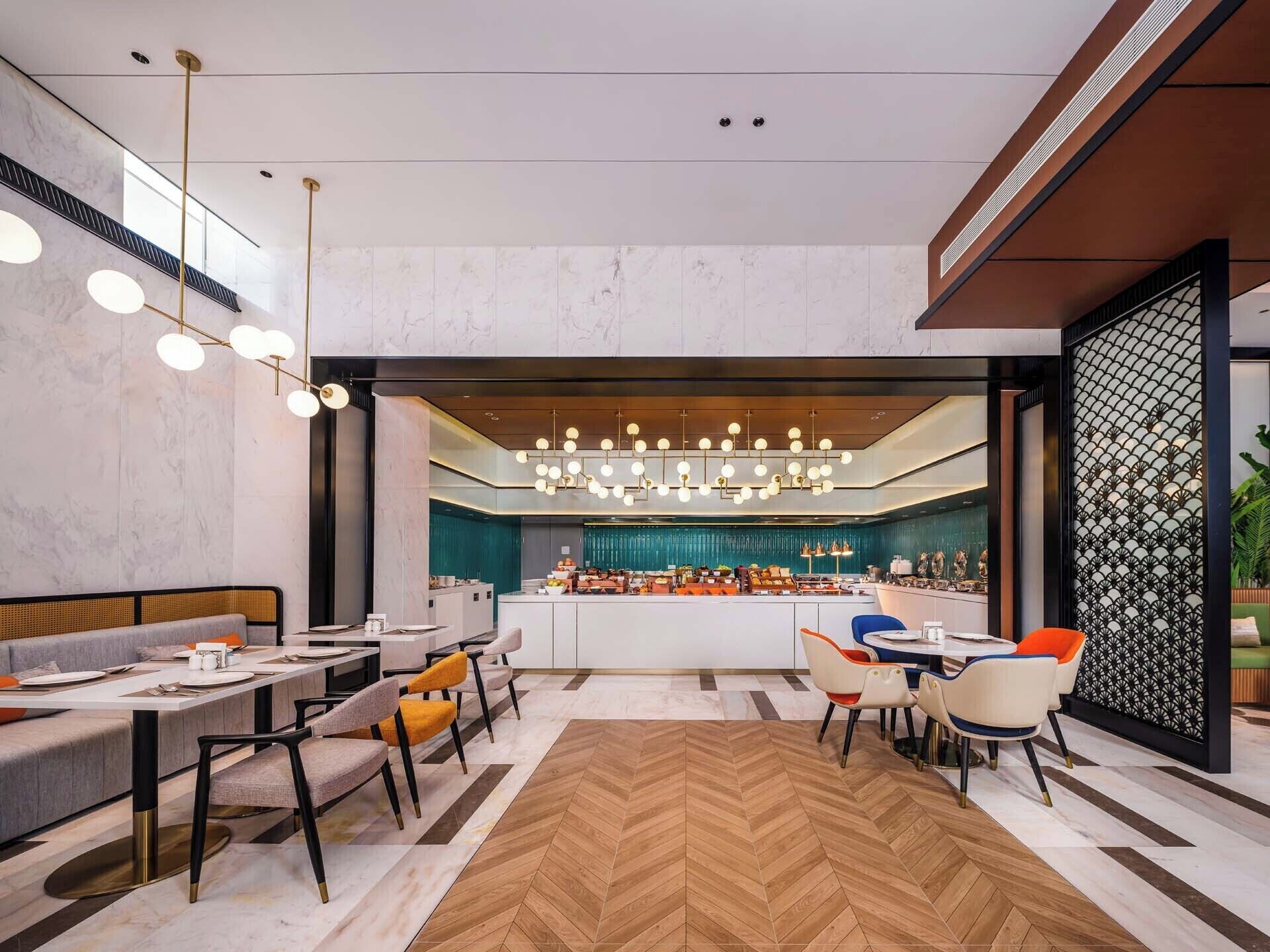 A modern interior with a central bar area, seating arrangements, and a herringbone patterned floor.
