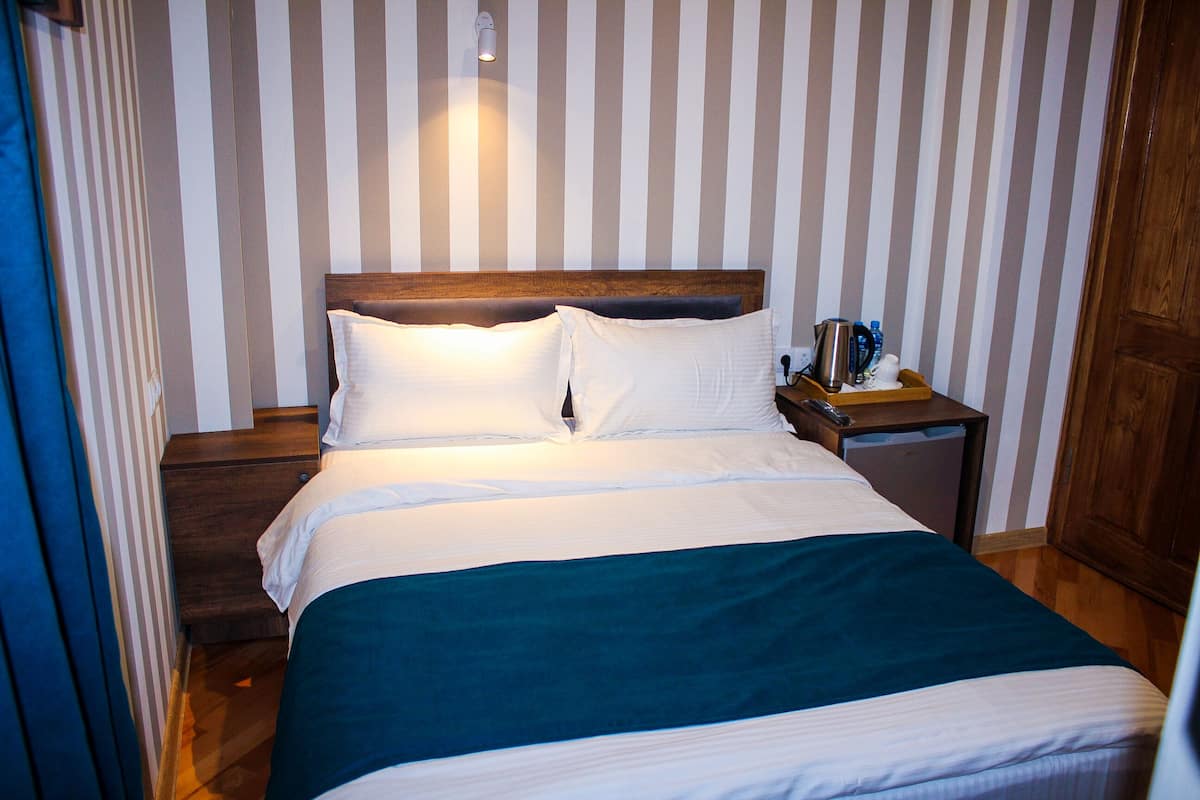 Economy Single Room | Blackout drapes, iron/ironing board, free WiFi, bed sheets