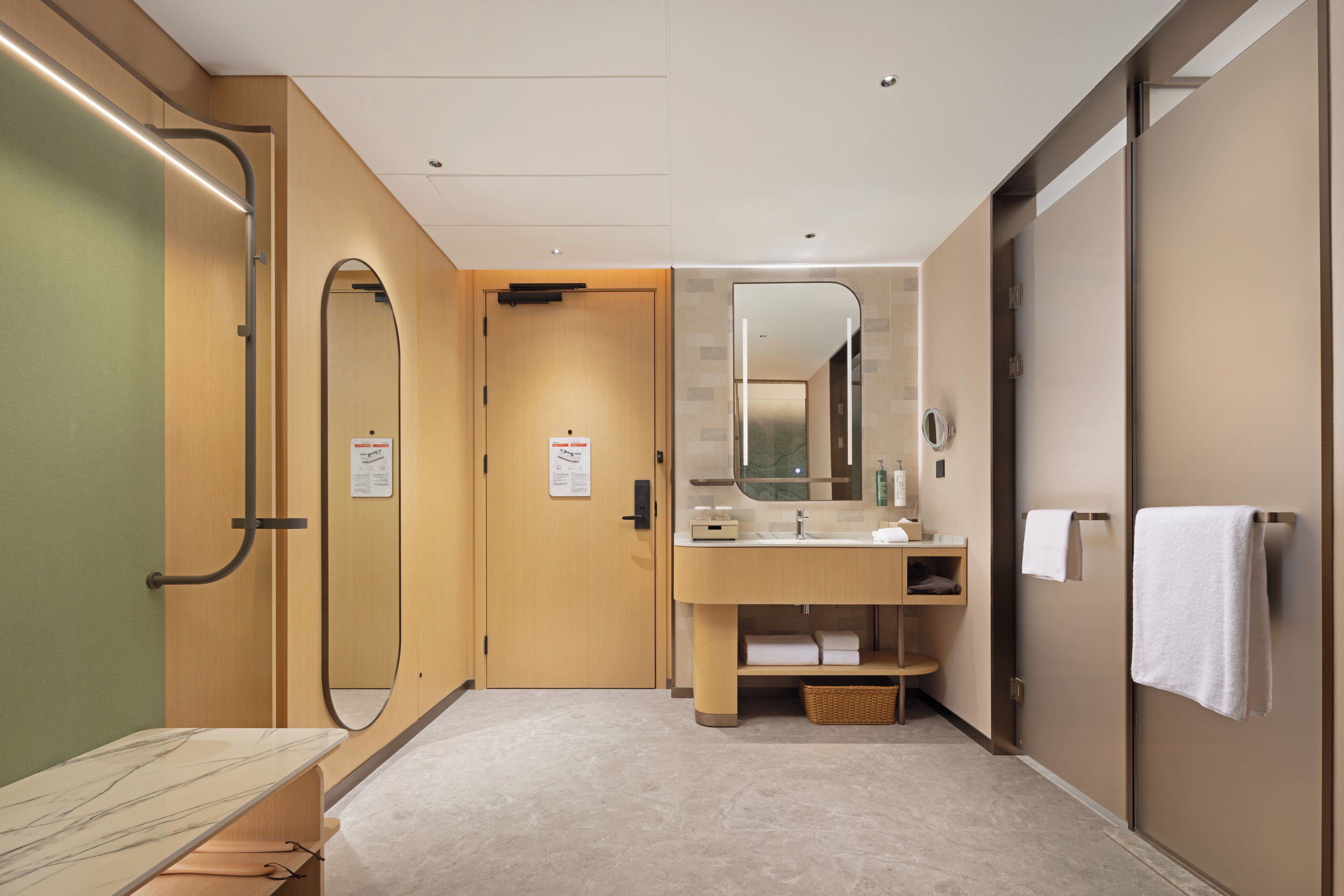 A modern bathroom with a large mirror, a sink, and a shower area.