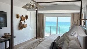 A modern bedroom with a large bed, a ceiling fan, and a view of the ocean. - "Dreamy Beachfront Getaway - Your Coastal Sanctuary Awaits!" (Placida)