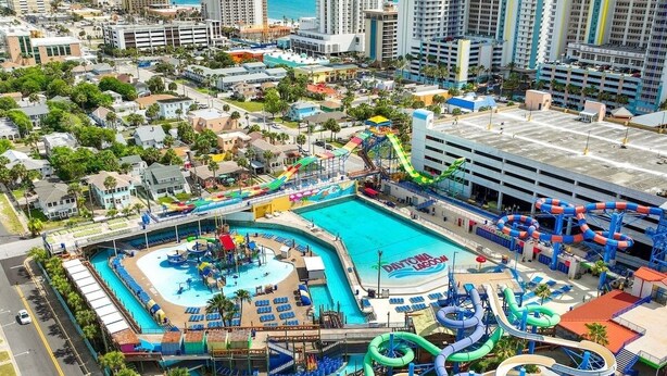A large water park with multiple slides and a central pool area.
