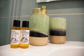 Two bottles and two containers on a white surface.