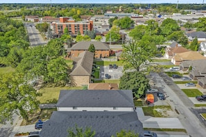 A residential area with houses, a parking lot, and a building with a red roof.