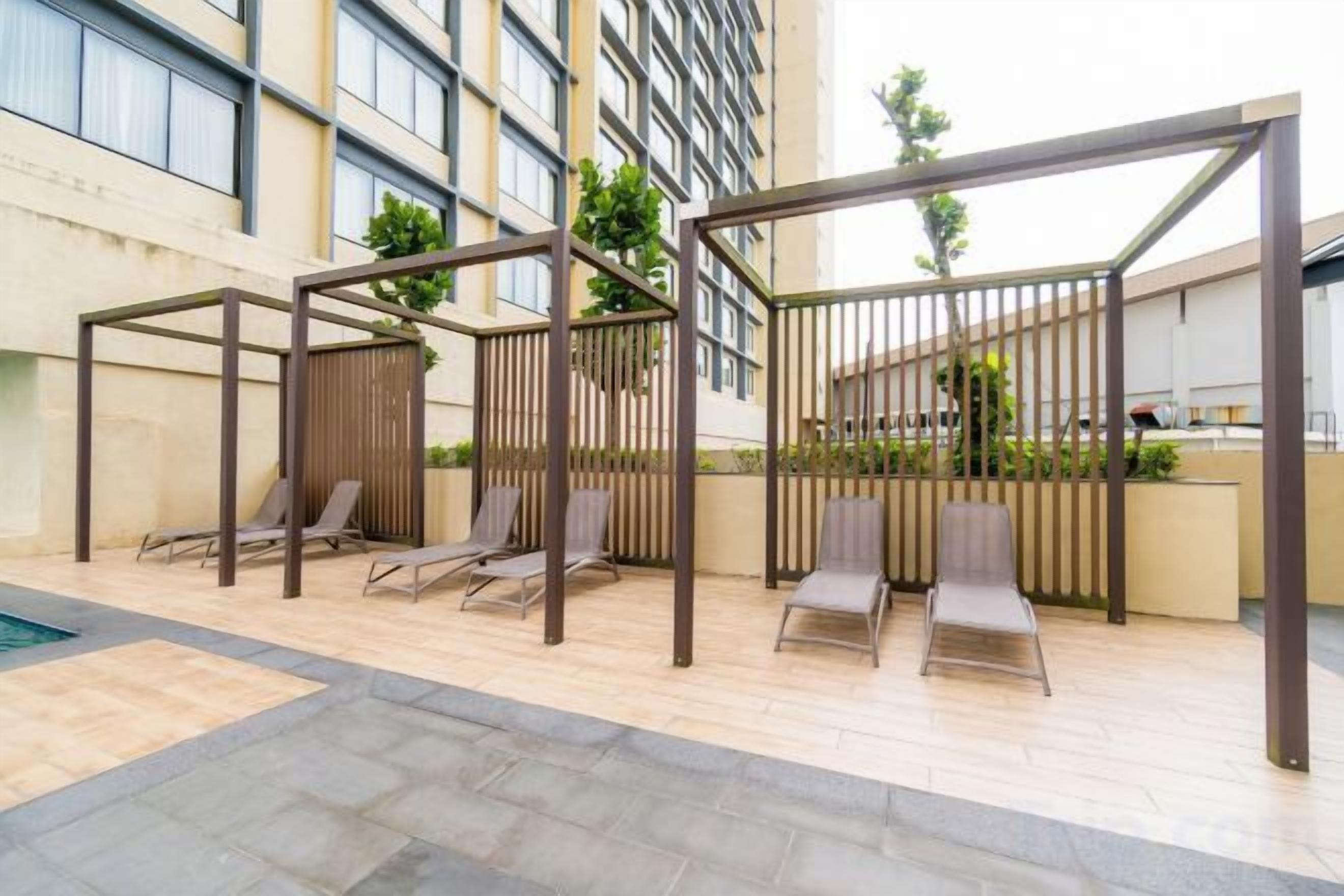 A rooftop terrace with outdoor seating and a pool.