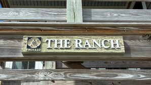 A wooden sign with "THE RANCH" and "FINCH & CO" on it.