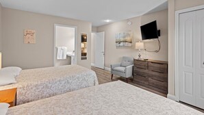 A hotel room with two beds, a desk, a chair, a TV, and a dresser. - 🛶 Torch Lake Vista | A-Ga-Ming Golf Retreat | Sunrise Views + Dual-Unit Condo ➠ 741 (Kewadin)