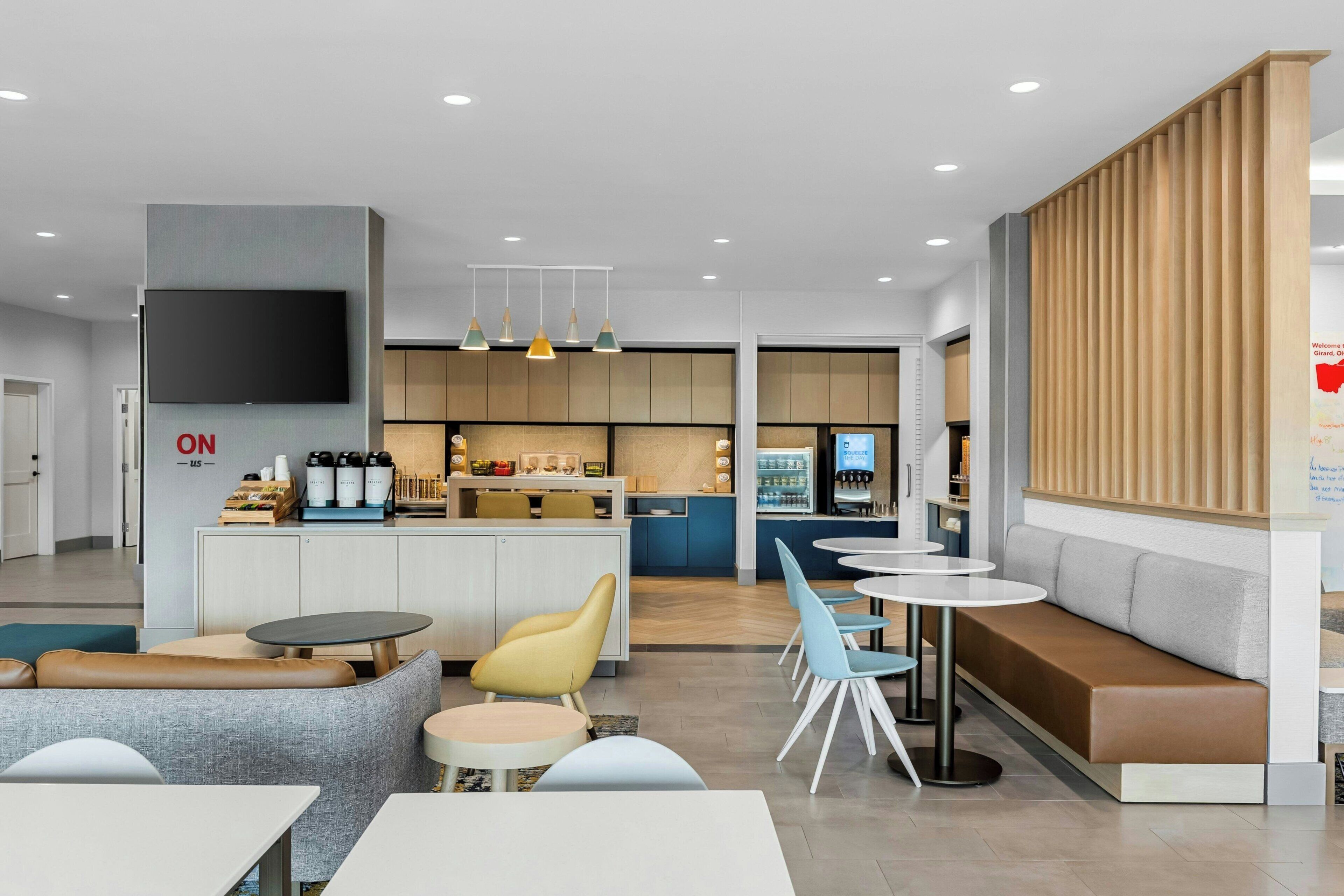 A modern interior with a bar area, seating, and a television.