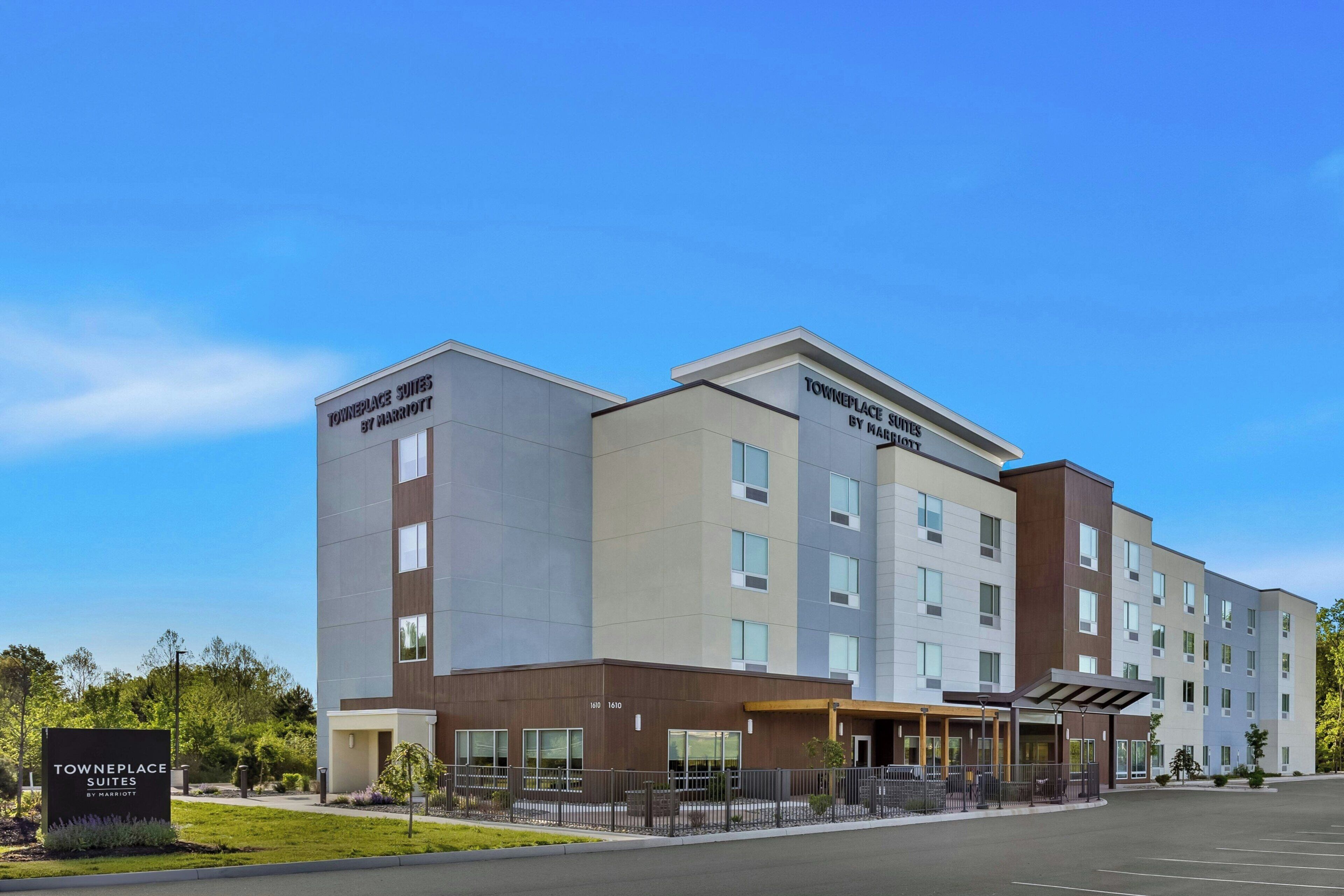 A multi-story hotel with a modern design, featuring a prominent entrance and signage for 'Towneplace Suites by Marriott.'
