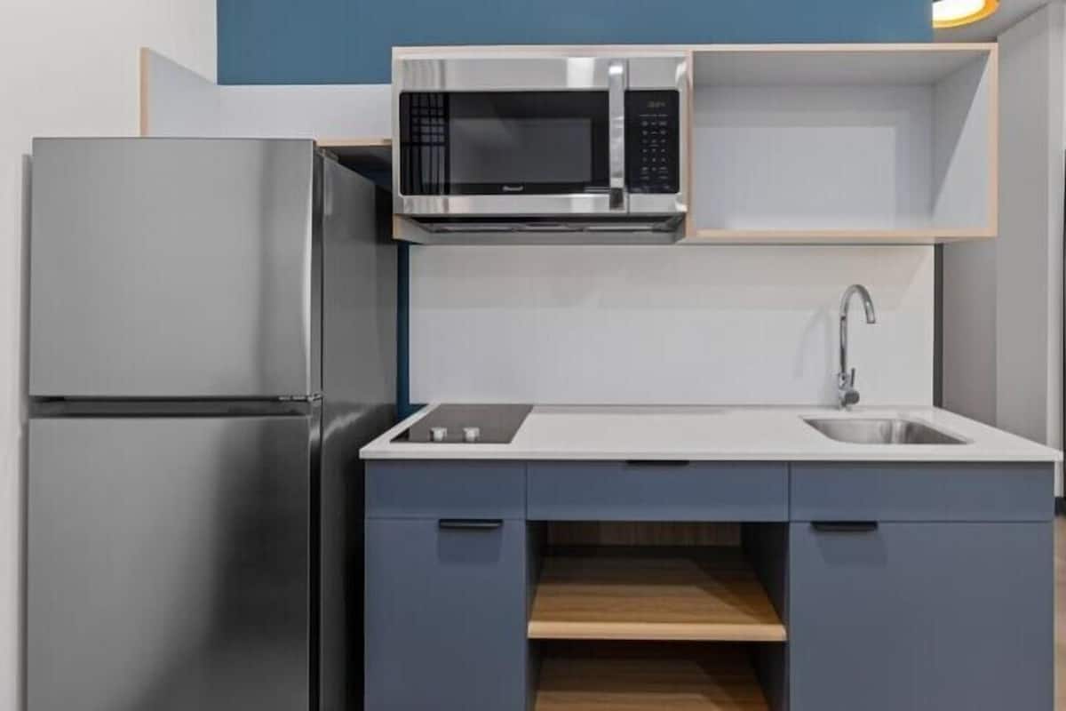 Een koelkast met diepvriezer, een microgolfoven, een kookplaat