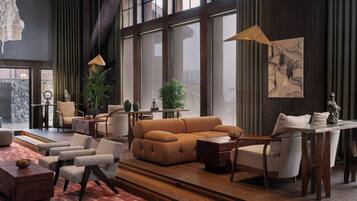 A spacious living room with a large window, a sofa, armchairs, a wooden coffee table, and a dining table with chairs.
