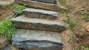 A stone staircase leading uphill with a grassy path beside it. - Dog-Kids and Family Friendly Riverfront Cabin! (Crumpler)