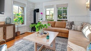 A living room with a sofa, coffee table, and a fireplace.