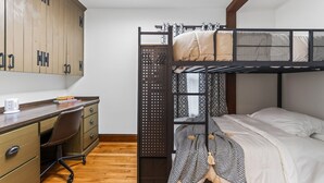 A bunk bed with a desk and chair, wooden wardrobe, and a small window. - Perfect Group Stay! See the Stunning Social Area X6 (Grandview)