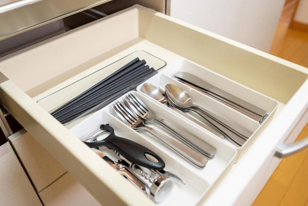 A drawer with utensils and kitchen tools.