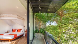 A bedroom with a bed, a nightstand, and a window overlooking a balcony with plants and a tree. - 6BRs w/ Private Pool & Billiard - 7min to Beach (Thành phố Hội An)