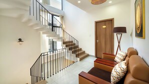 A modern interior with a staircase, a sofa, and a lamp. - 6BRs w/ Private Pool & Billiard - 7min to Beach (Thành phố Hội An)