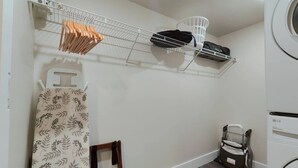 A laundry room with a washing machine, a drying rack, and a shelf with cleaning supplies. - Studio Apt Near Temple Unit with Free Parking for Extended Stays (Philadelphia)