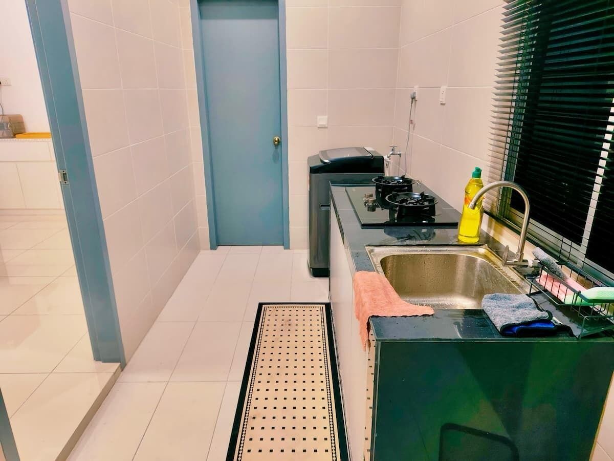 A compact kitchen with a sink, a stove, and a small countertop.